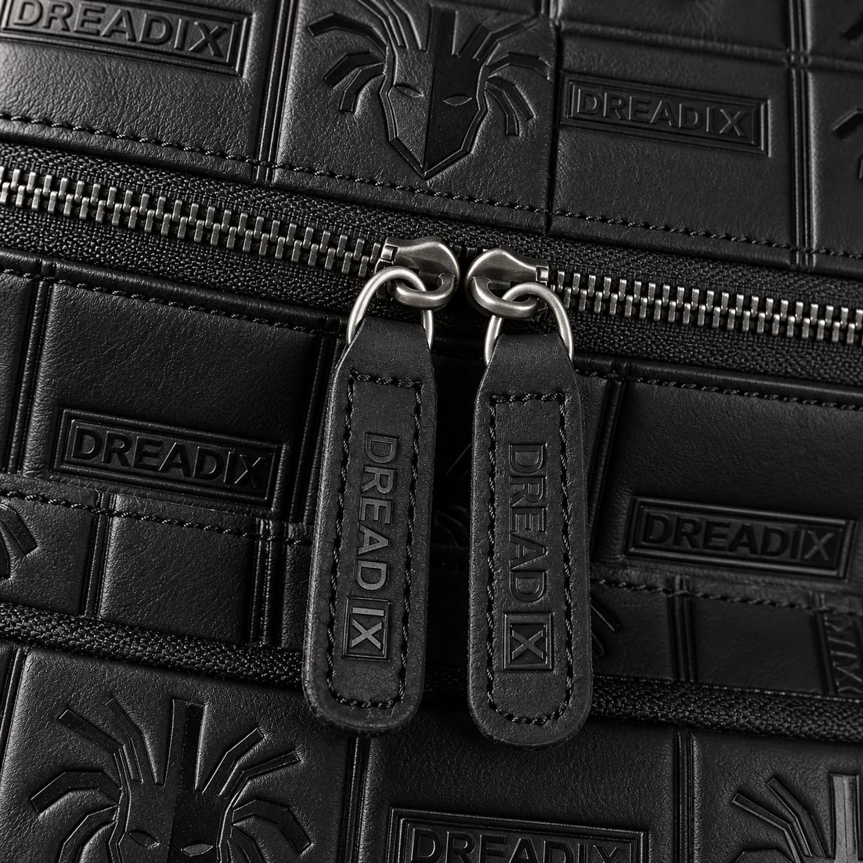 Close view of DREAD IX embossed black leather and zipper hardware